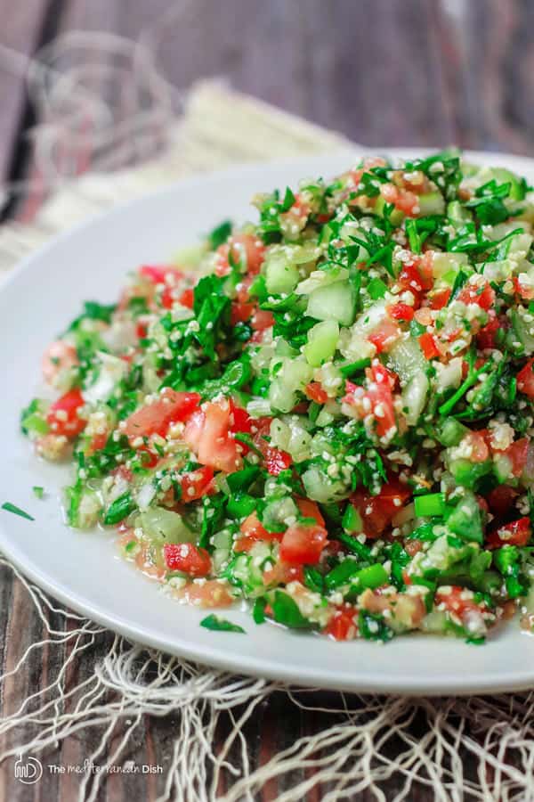 Tabouli Recipe (Tabouleh) | The Mediterranean Dish. Authentic Middle Eastern tabouli salad with fresh parsley, mint, bulgur, finely chopped vegetables and a simple citrus dressing. See the step-by-step tutorial at The Mediterranean Dish food blog.