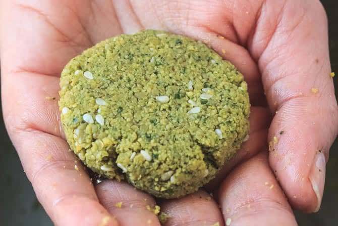 One falafel patty formed by hand before frying