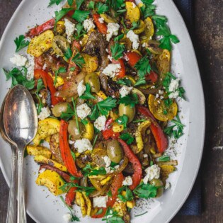 Sauteed Yellow Squash with Sweet Onions and bell peppers. Served with a garnish of feta cheese, olives and parsley