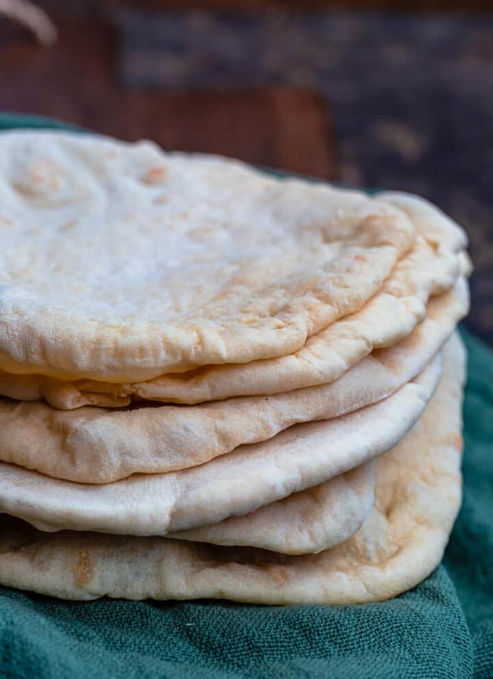 Stack of pita bread over a kitchen towel