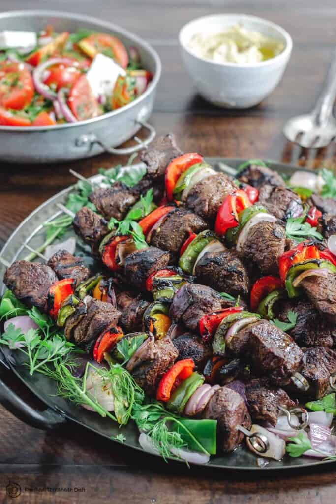 Kabobs with a side of tomato salad