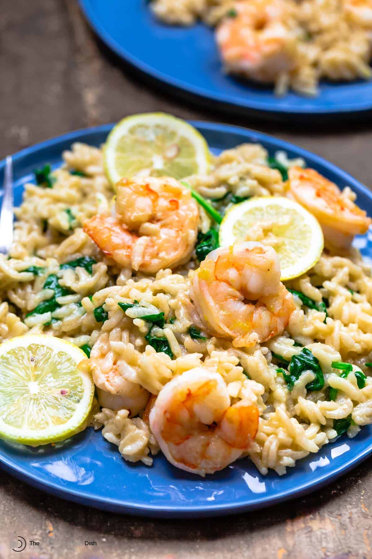 risotto with shrimp and lemon on a blue plate