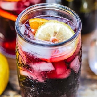 Glass of tinto de verano showing the lemon wheel garnish.