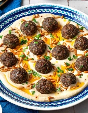 middle eastern meatballs over hummus web story poster image.