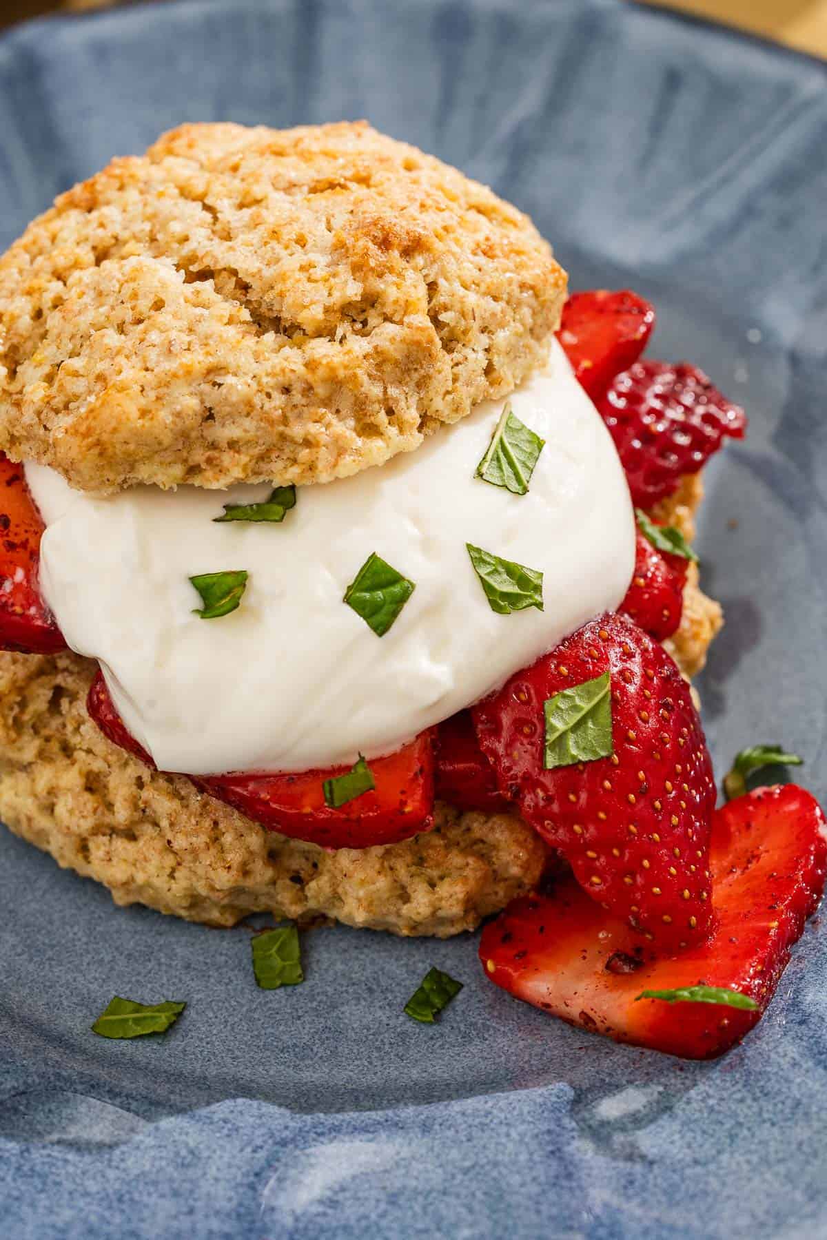 A close up of a strawberry shortcake on a plate.