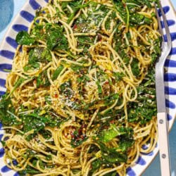 An overhead photo of za'atar garlic spinach pasta on a serving platter with a fork.