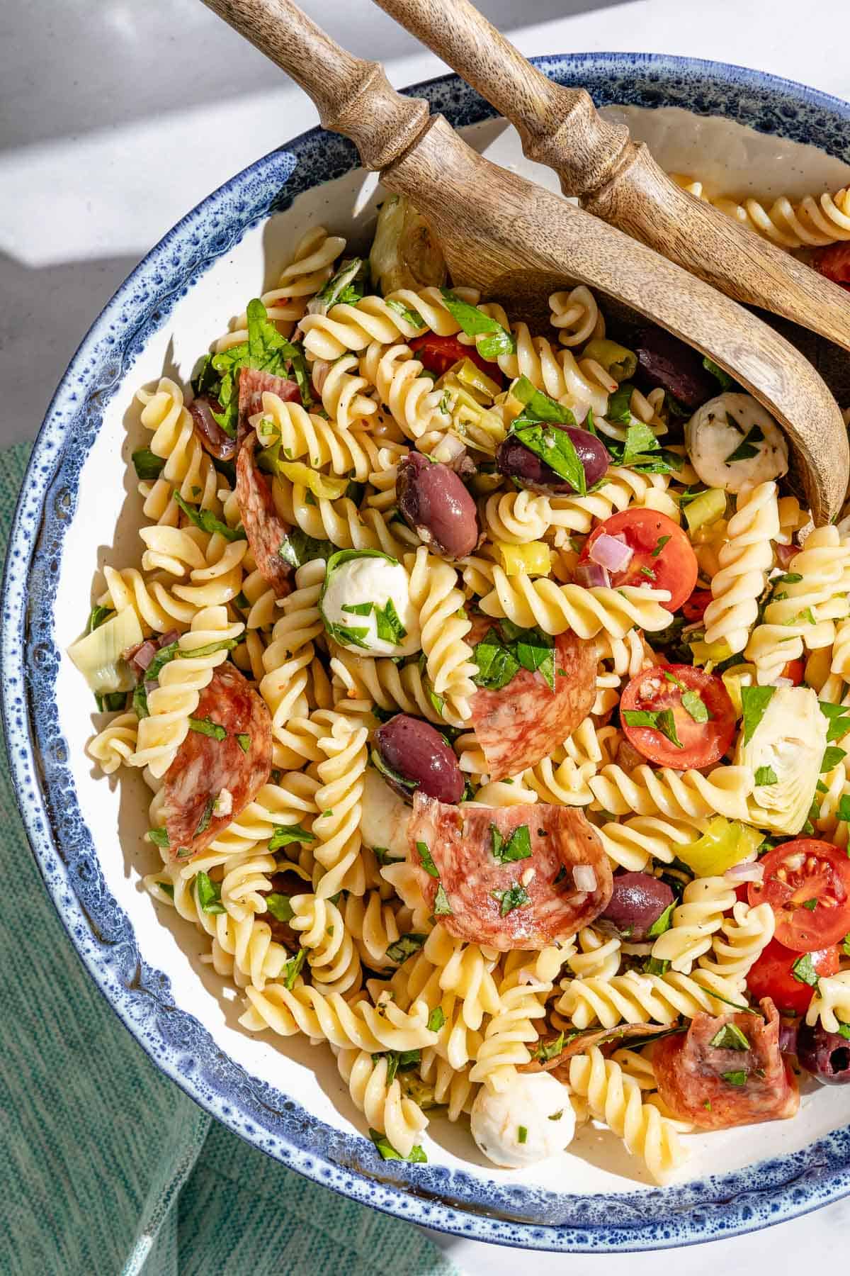 Close up of Italian pasta salad in a serving bowl on a sunny day.