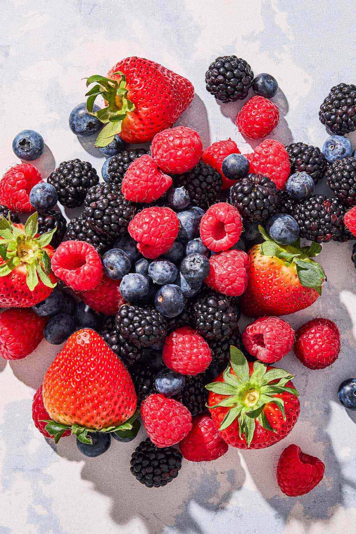 A close up of a blueberries, blackberries and strawberries.