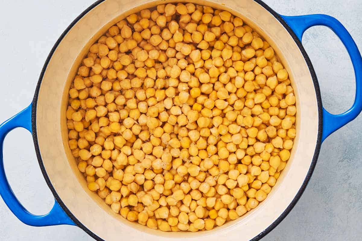 Chickpeas in water in a large pot.