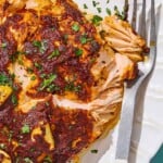 A close up of Turkish style salmon on a serving platter with a fork.