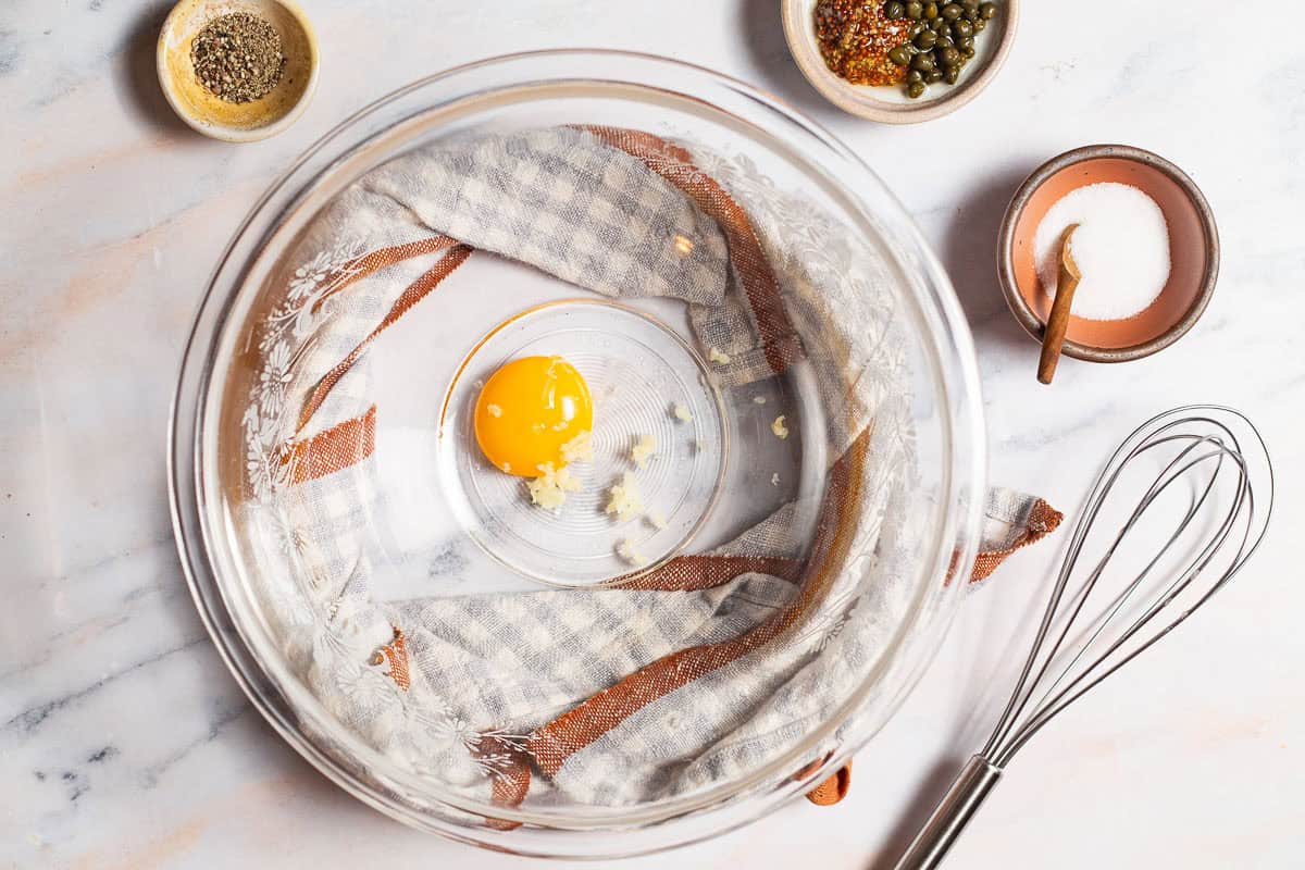 egg yolk and garlic in a mixing bowl.