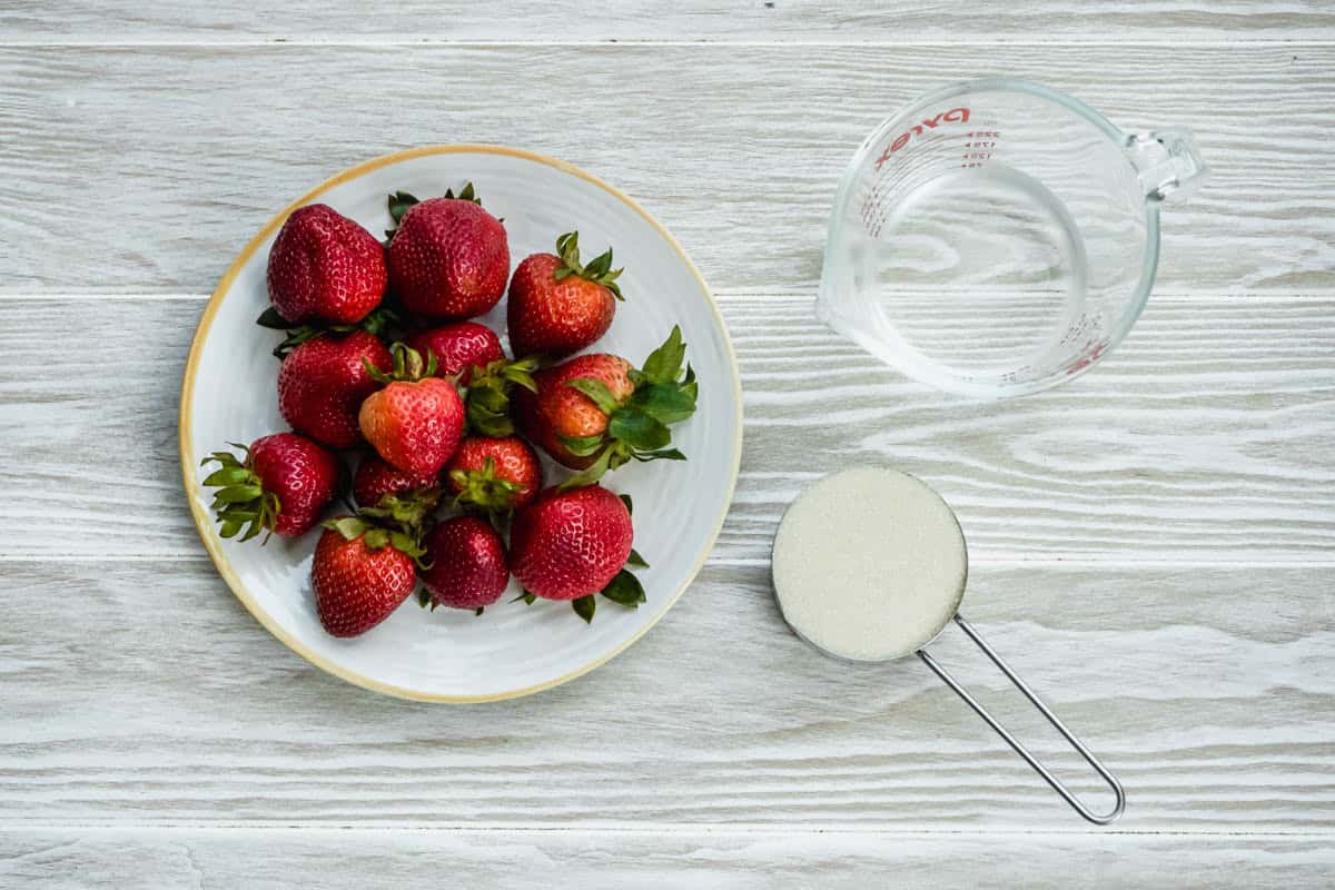 Ingredients for strawberry granita including strawberries, water and sugar.