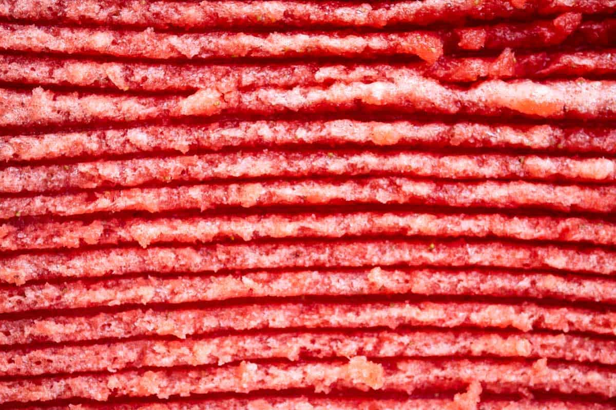 A close up of strawberry granita an a pan after being scraped with a fork.