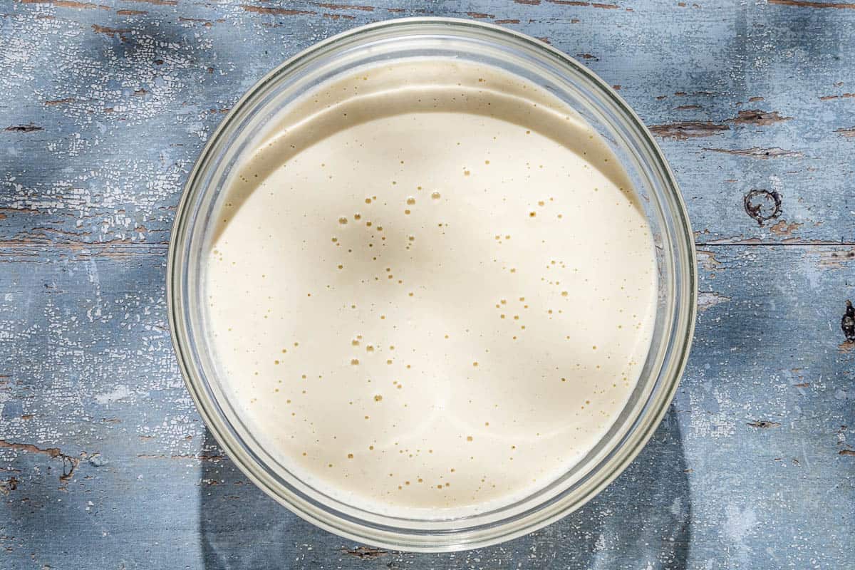 An overhead photo of the ajo blanco white gazpacho in a large bowl.