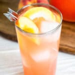 A close up photo of a glass of peach lemonade.