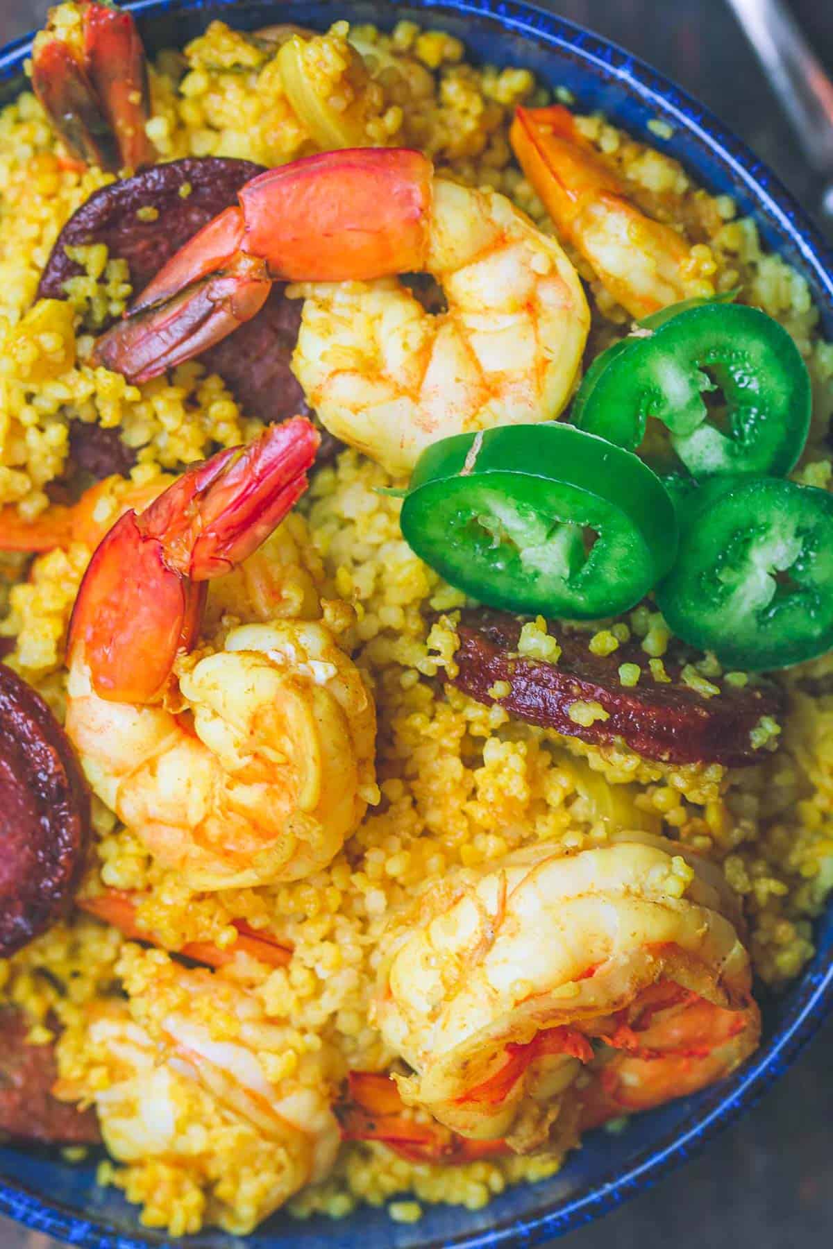 A close up overhead photo of shrimp couscous in a bowl.
