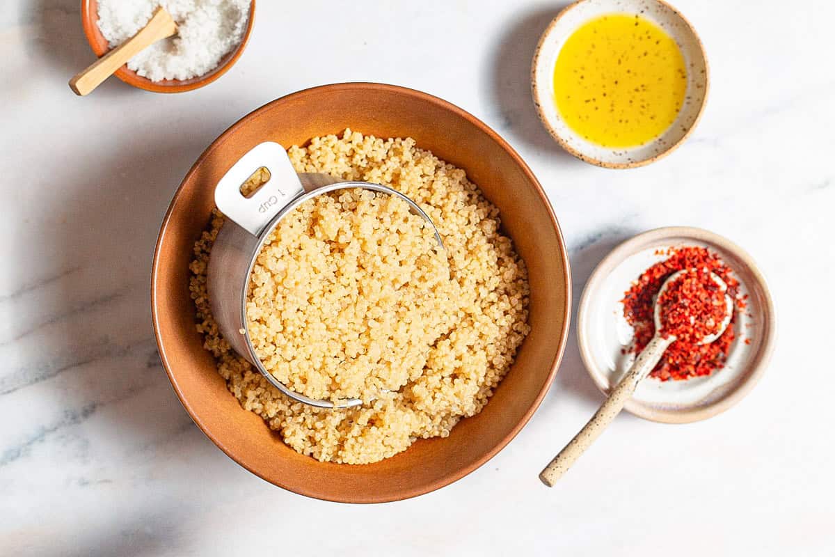 Ingredients for crispy quinoa including cooked quinoa, olive oil, kosher salt, and aleppo pepper.