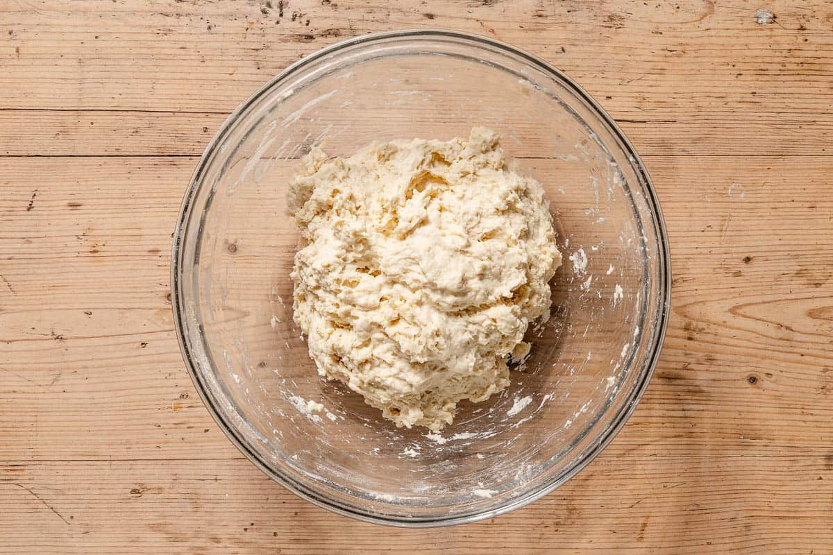 Dough in a mixing bowl just after being mixed together.