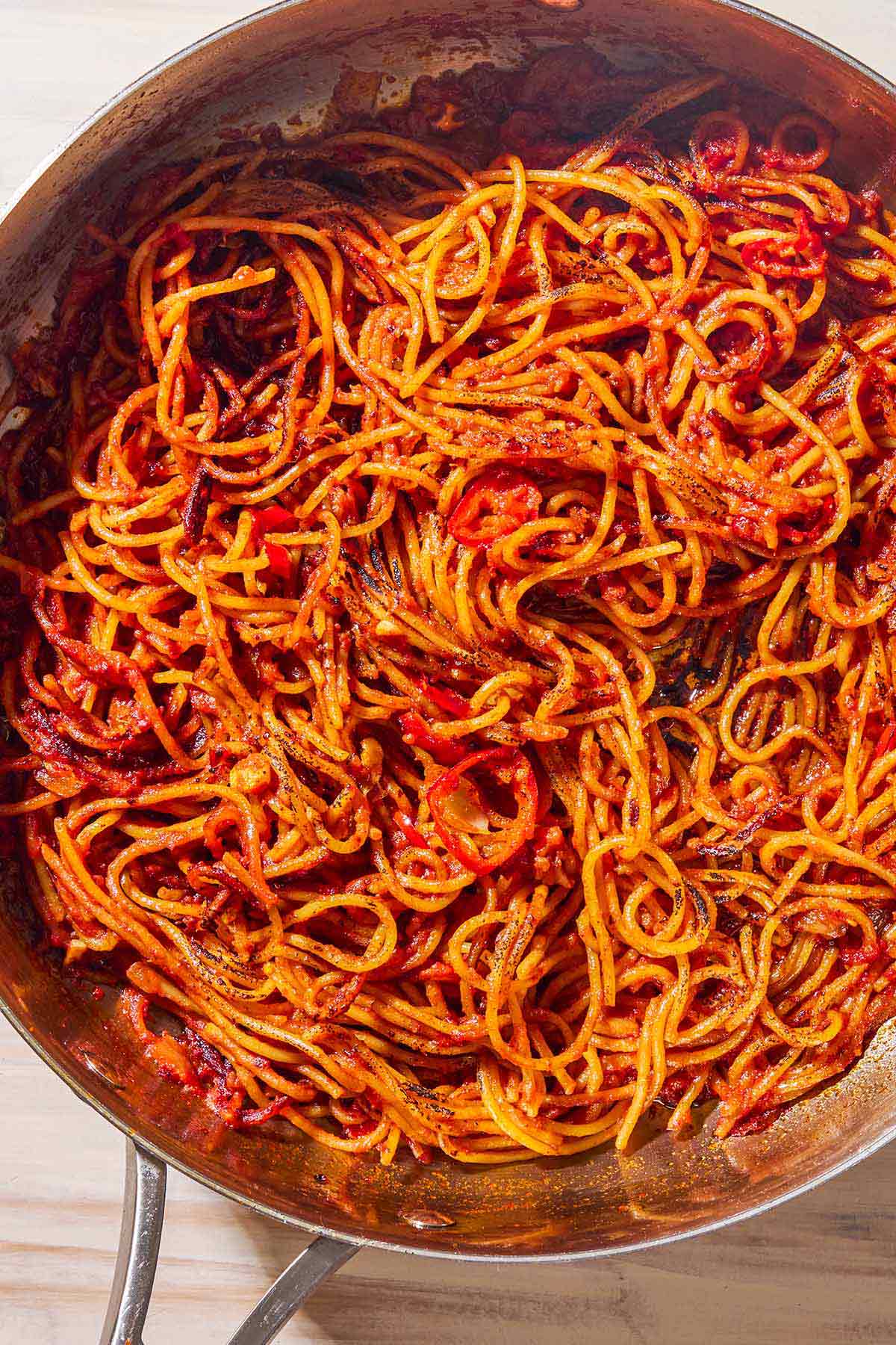 An overhead photo of spaghetti all'assassina in a skillet.