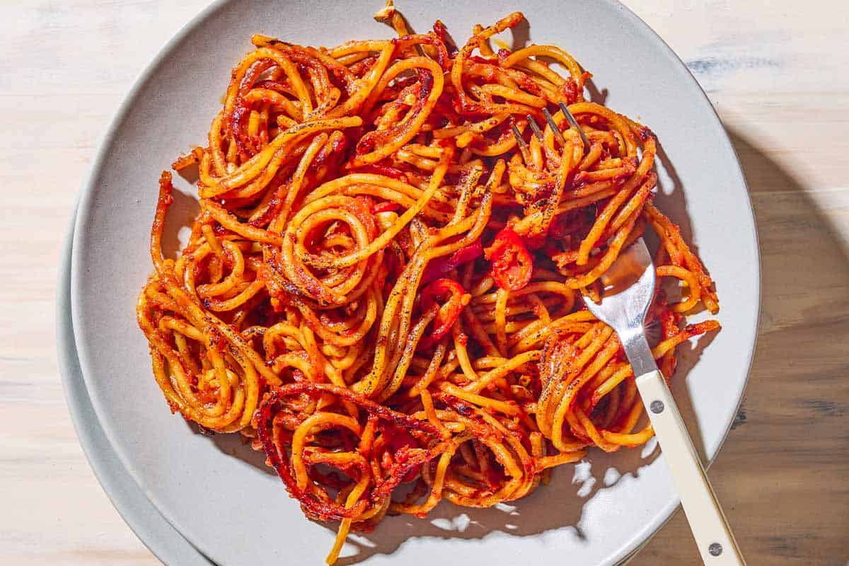 An overhead photo of a serving spaghetti all'assassina on a plate with a fork.