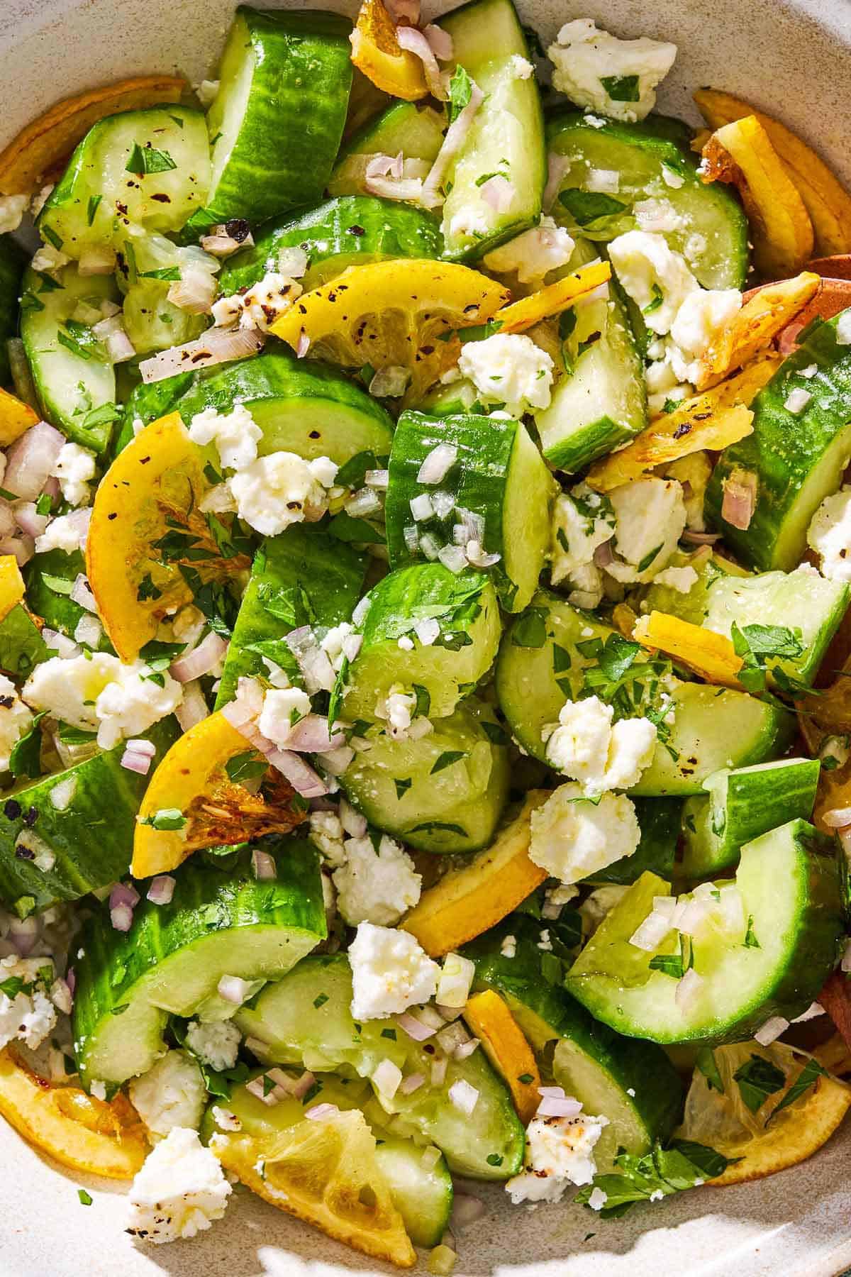 A close up of smashed cucumber salad in a serving bowl.