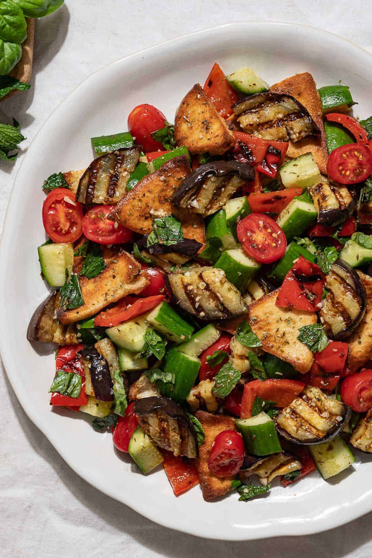 An overhead photo of grilled eggplant salad on a serving platter.