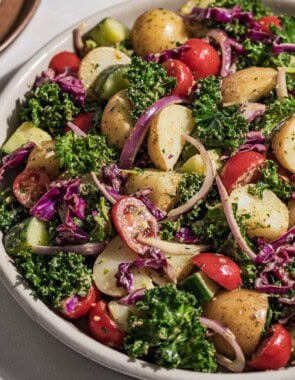 A close up of pesto potato salad in a serving bowl.