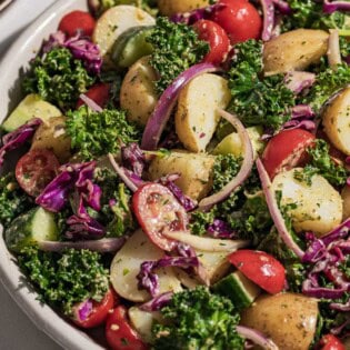 A close up of pesto potato salad in a serving bowl.