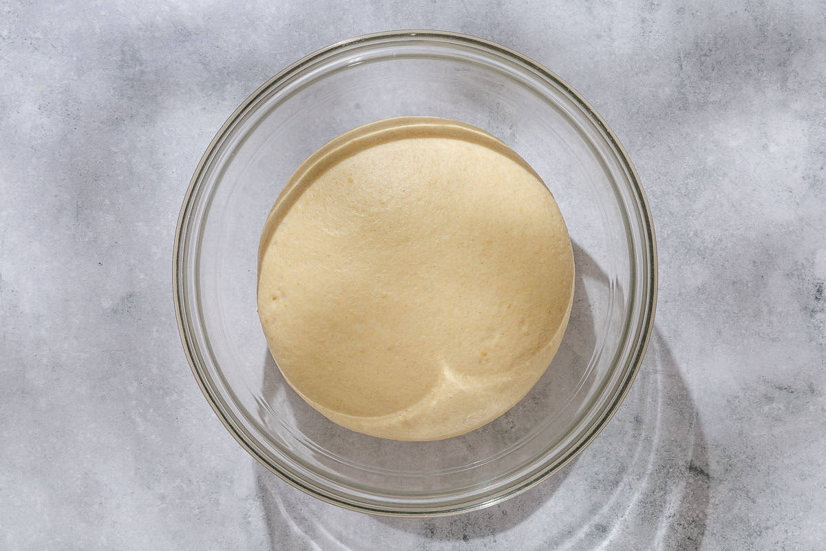 The dough for the sesame breadsticks in a bowl.