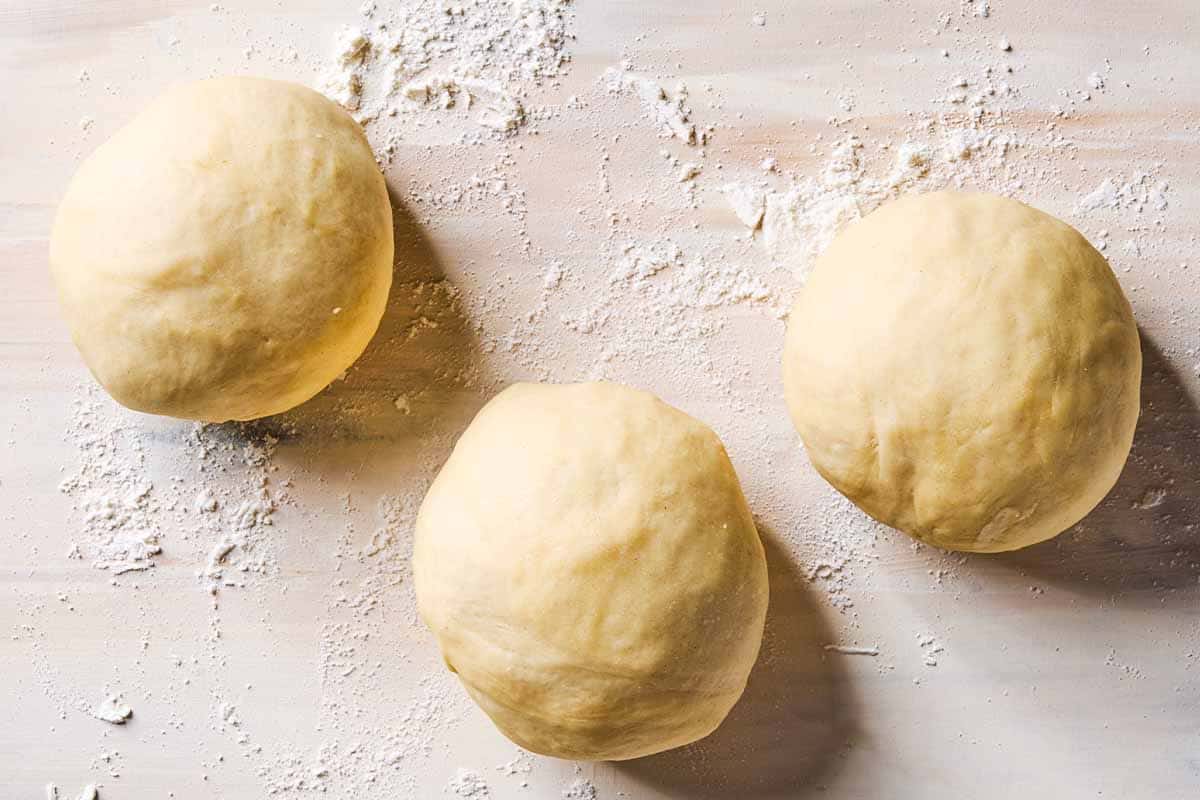 A close up photo of 3 balls of dough.