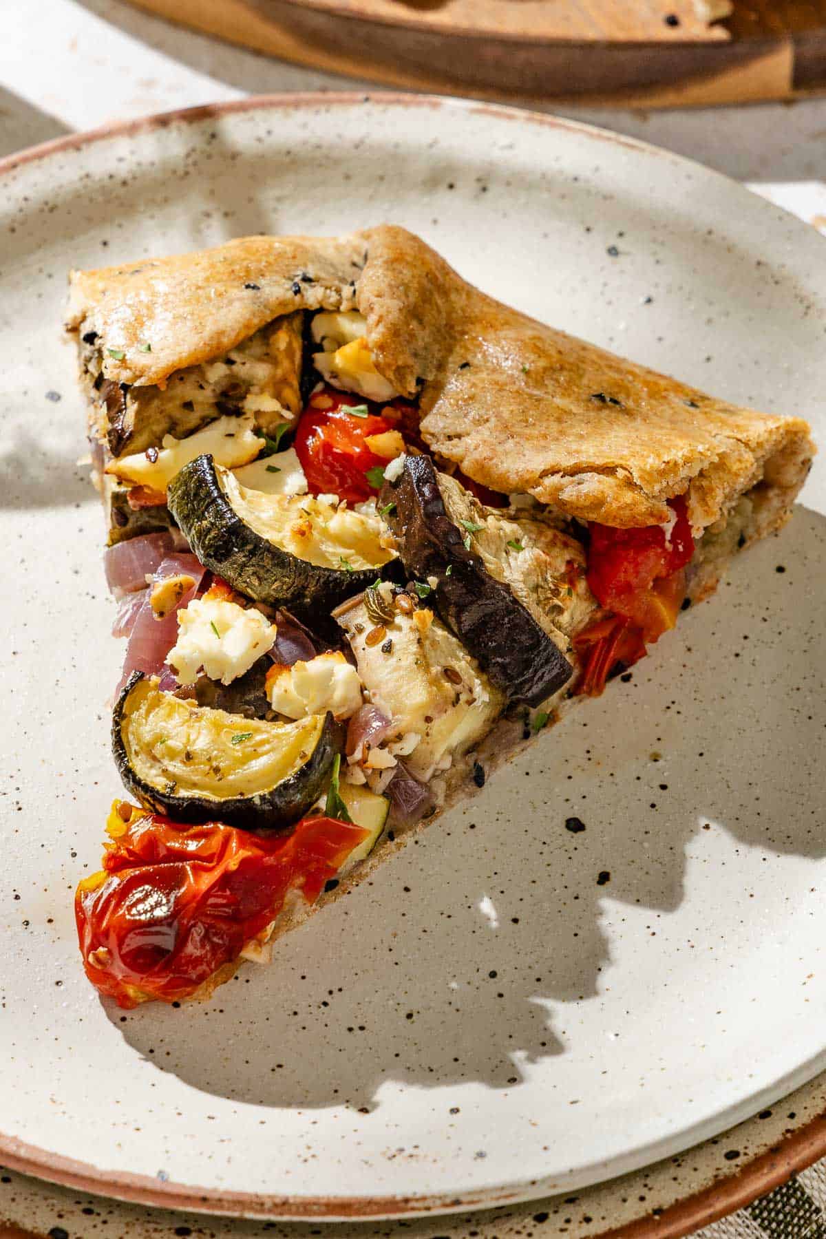 A close up of a slice of the savory galette on a plate.