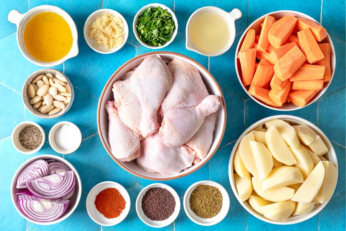 Ingredients for za'atar chicken including chicken thighs and drumsticks, potatoes, carrots, red onion, salt, black pepper, blanched almonds, parsley, za'atar, sumac, sweet paprika, garlic, lemons and olive oil.