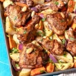 A close up photo of sheet pan za'atar chicken with veggies next to a small bowl of chopped parsley.