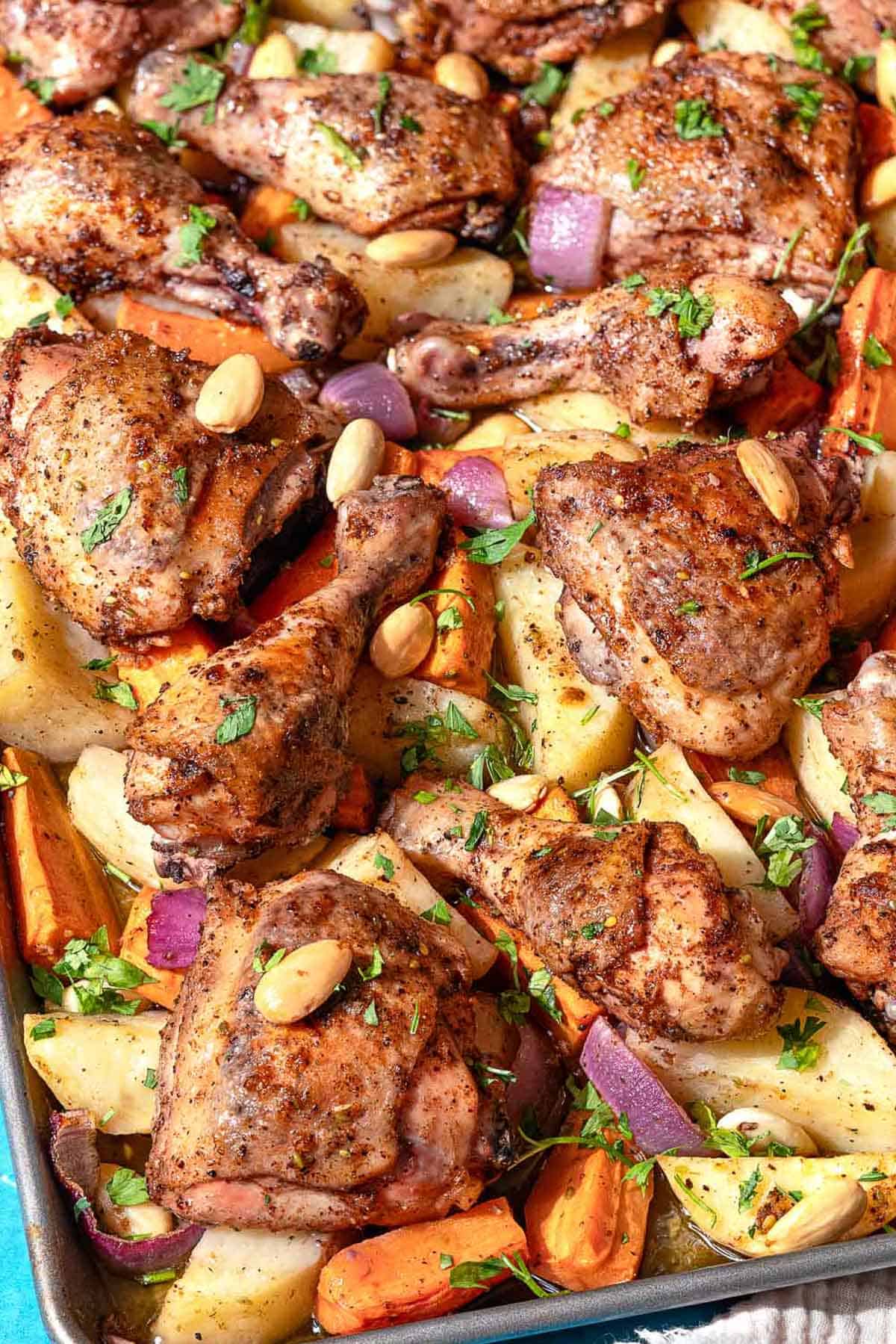 A close up photo of sheet pan za'atar chicken with veggies.