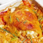 A close up photo of the one pan tomato chicken with baharat, tarragon, and couscous in a baking dish.