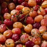 A close up of roasted grapes with sherry and thyme.