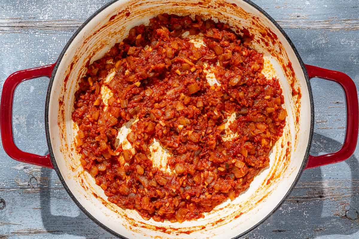 An overhead photo of the sofrito for the Spanish meatballs in a skillet.