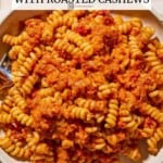 A bowl of pasta dressed in sun dried tomato pesto.