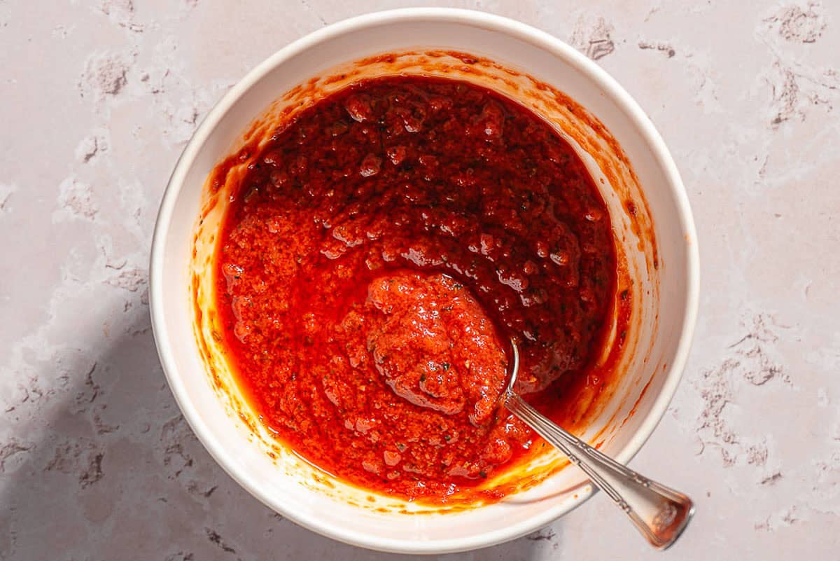 An overhead photo of the chicken rub in a bowl with a spoon.