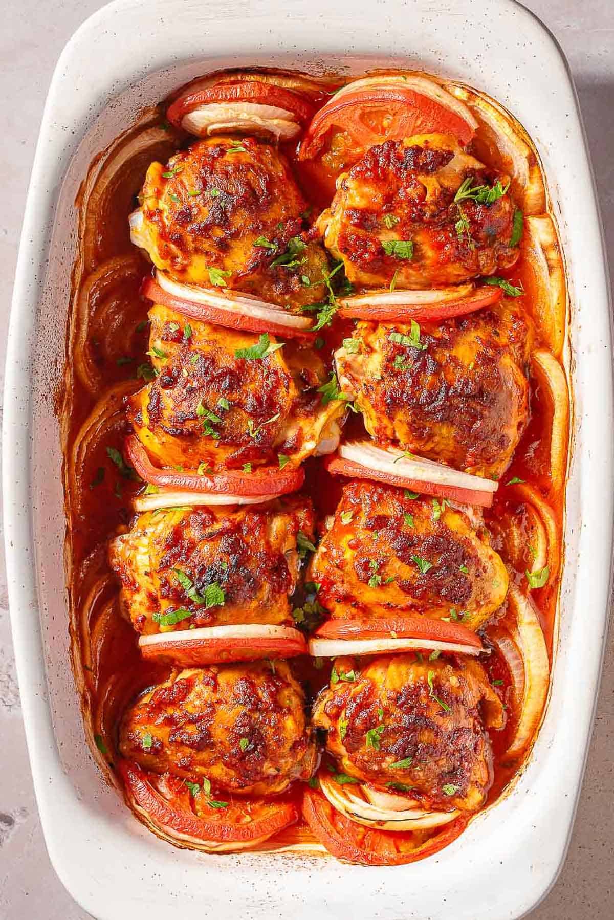 An overhead photo of baked chicken thighs in a baking dish.