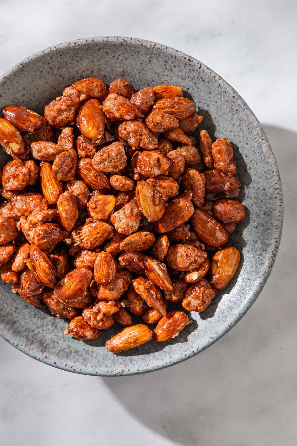 An overhead photo of candied almonds in a bowl.