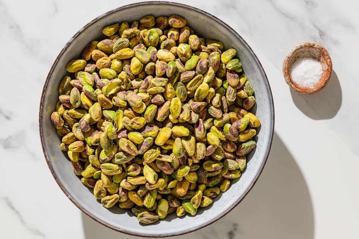 Ingredients for pistachio butter including raw shelled pistachios and kosher salt.