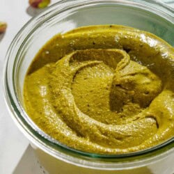 A close up of pistachio butter in a small bowls.