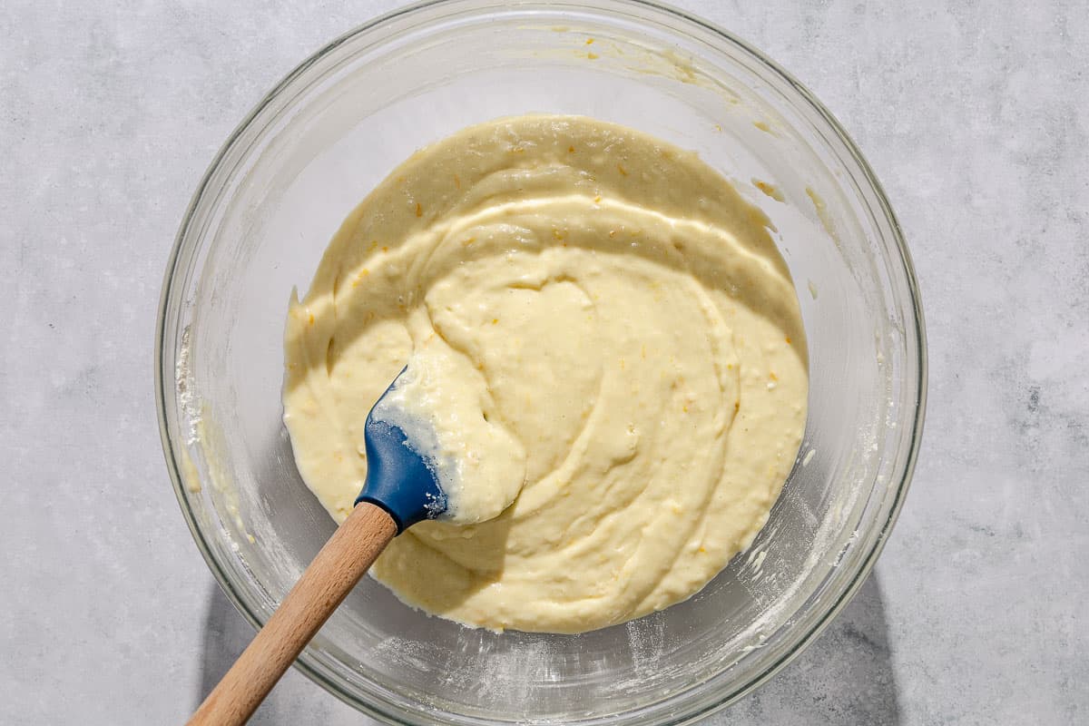 The batter for the Italian pear cake in a mixing bowl with a spatula.