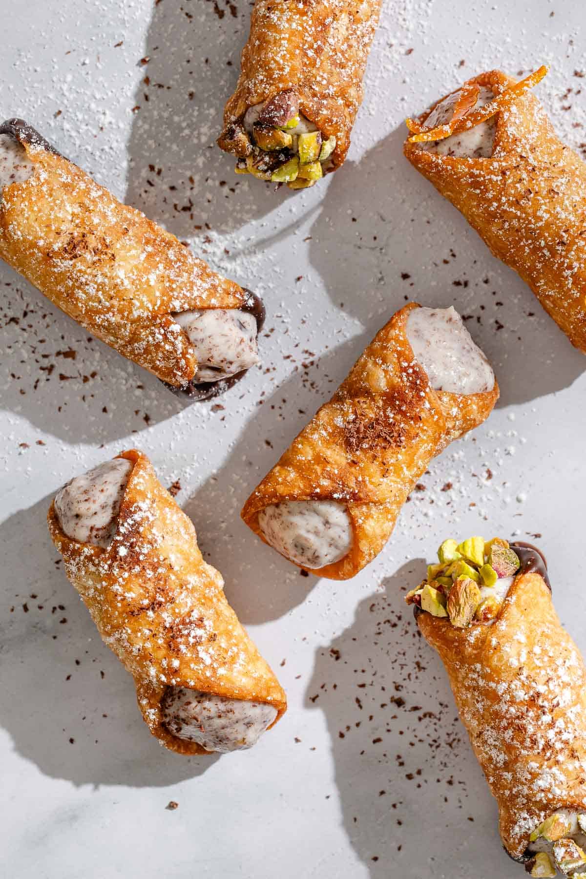 An overhead photo of 6 filled cannolis.