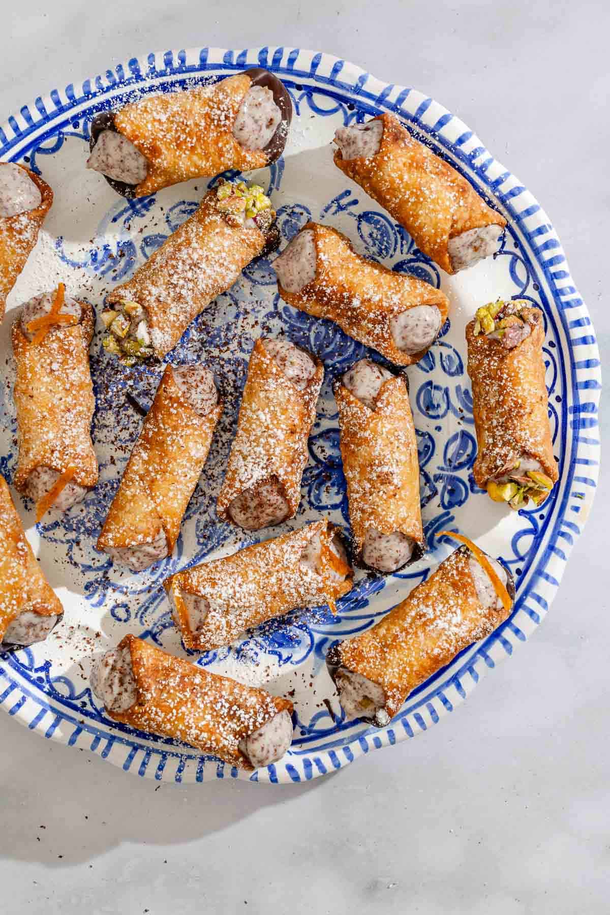 An overhead photo of several cannolis on a plate.