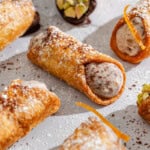 A close up of several filled cannolis.