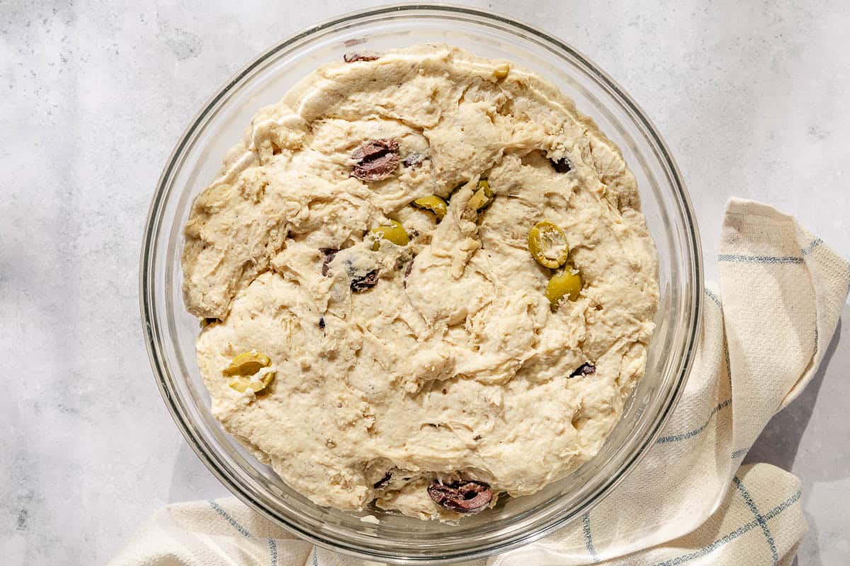 An overhead photo of the olive bread dough after its first rise.