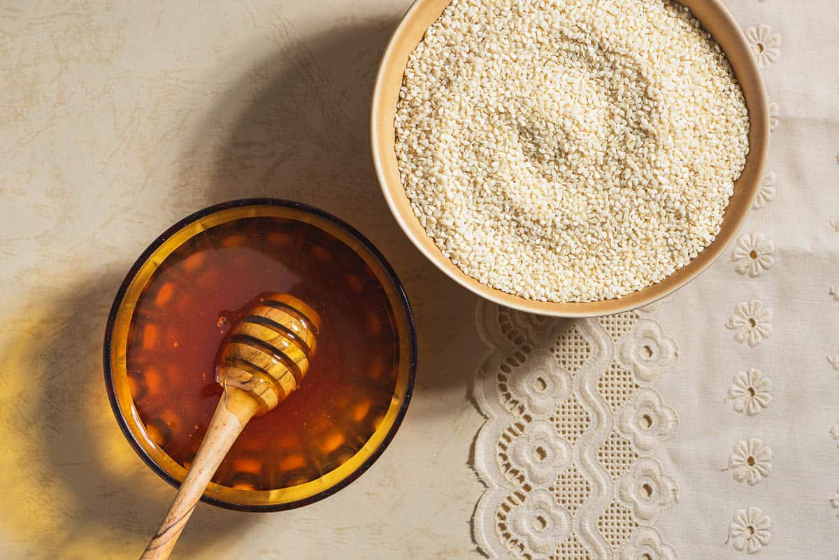 Ingredients for greek sesame candy with honey including sesame seeds and honey.