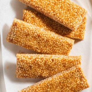 Several pieces of greek sesame candy on a plate.